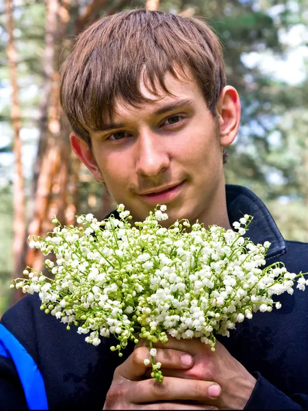Guy with lilies of the valley — Stock Photo, Image