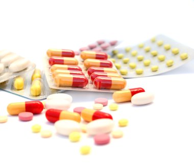 Medical pills and tablets on white background. clipart