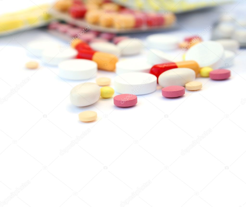 Medical pills and tablets on white background.