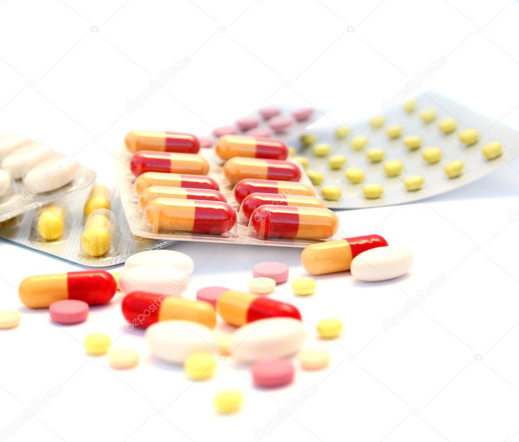 Medical pills and tablets on white background.