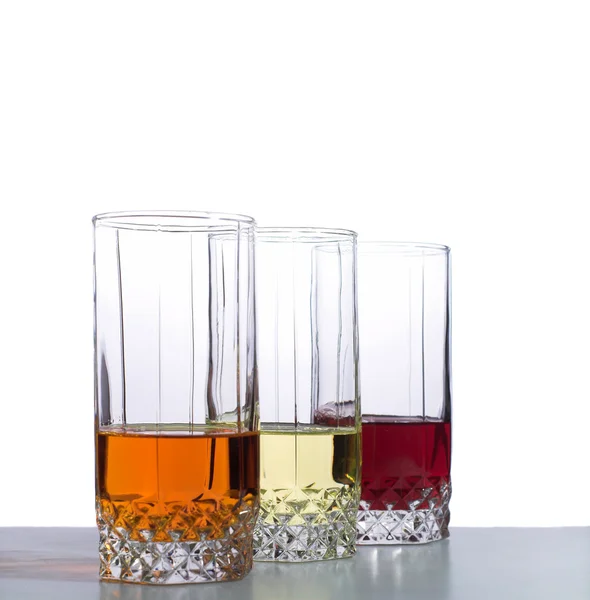 Tiga gelas terisolasi di atas meja — Stok Foto