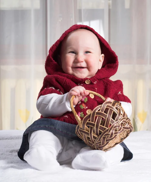 Smiling baby with basket — Stock Photo, Image