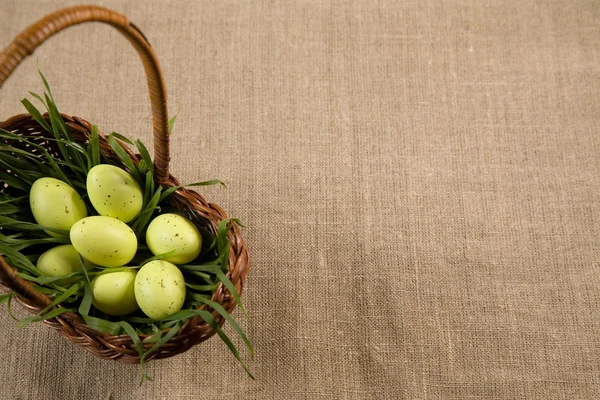 Basket with Easter eggs in grass — Stock Photo, Image