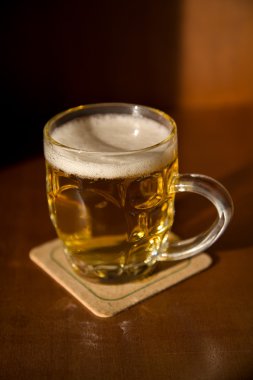 Beer mug on a coaster clipart