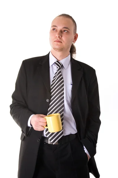 Serious looking businessman holding coff — Stock Photo, Image