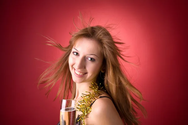 Улыбающаяся девушка с летящими волосами и шампанским — стоковое фото