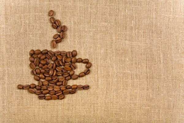 Φλιτζάνι καφέ πάνω από το φόντο του καμβά — Φωτογραφία Αρχείου
