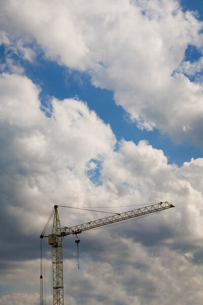 Construction crane over cloudy sky