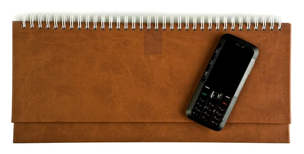 Mobilní telefon na notebook — Stock fotografie
