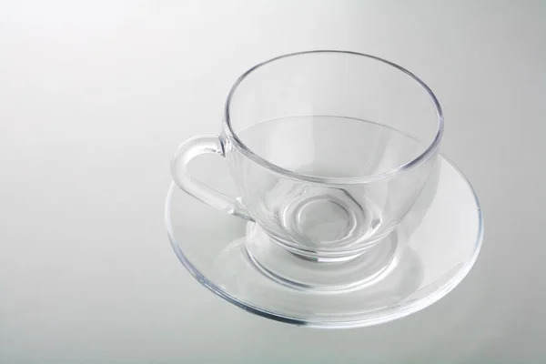 Tasse auf Teller isoliert auf grau — Stockfoto