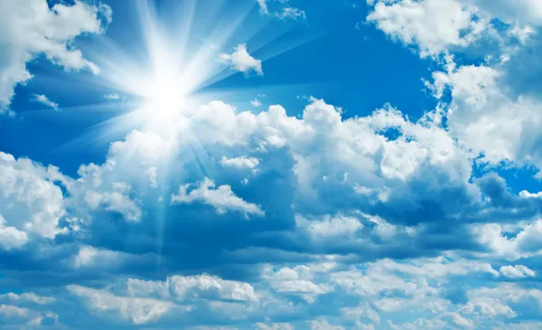 Blue cloudy sky with sun — Stock Photo, Image