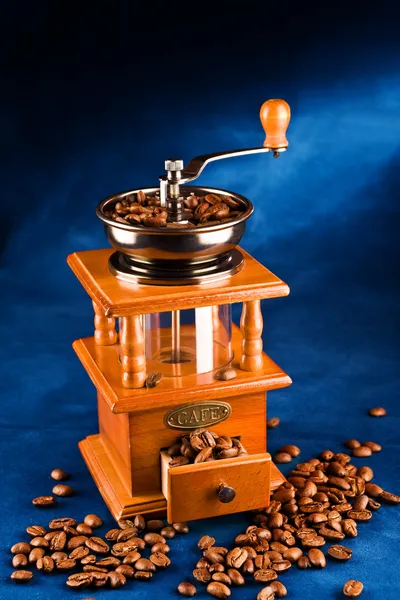 Manual coffee grinder with grains — Stock Photo, Image