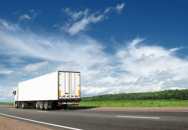 White truck speeding away on highway clipart