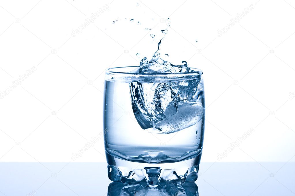 Ice splashing in a cool glass of water