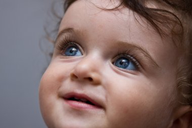 Curly baby boy with blue eyes clipart