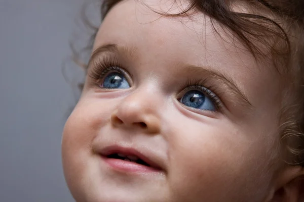 Curly baby boy with blue eyes — Stock Photo, Image