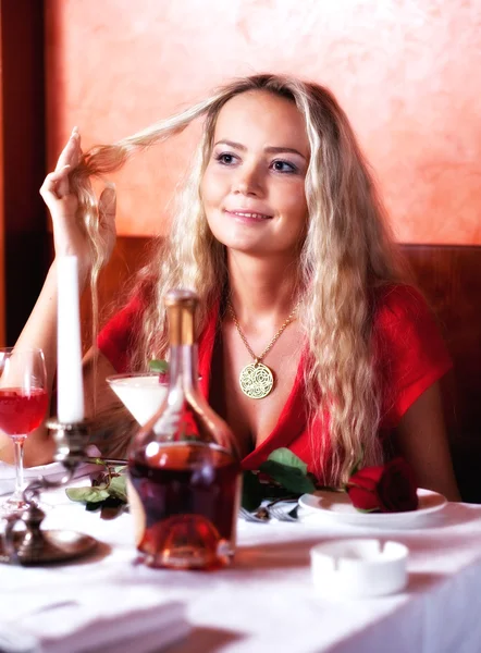 The beautiful girl in red at restaurant — Stock Photo, Image