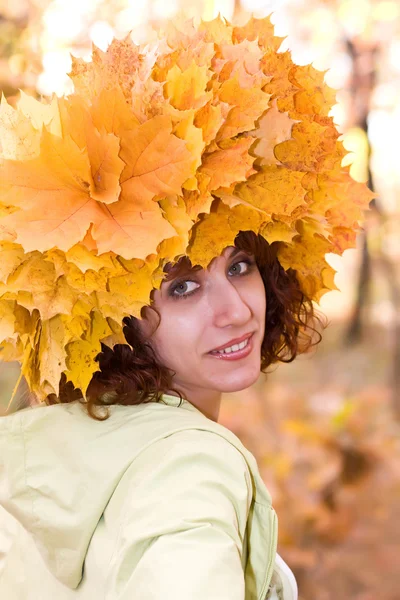 Girl in a wreath from autumn leaves Royalty Free Stock Photos