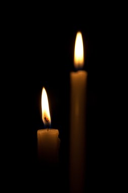 Candles isolated on black background clipart