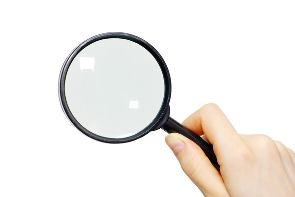 Hand holding a magnifying glass on white