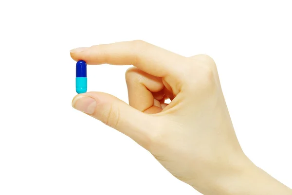 Píldora en dedos —  Fotos de Stock