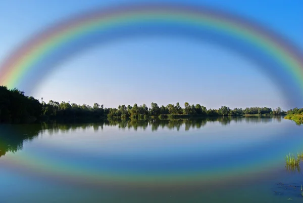 stock image summer rainbow over the lake 