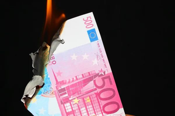 Stock image burning euro banknotes on a dark background 