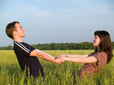 Young Couple Walking Field Holding Hands clipart