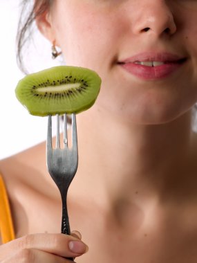 Teen eats kiwi clipart