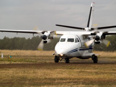 Commuter plane on taxiway clipart