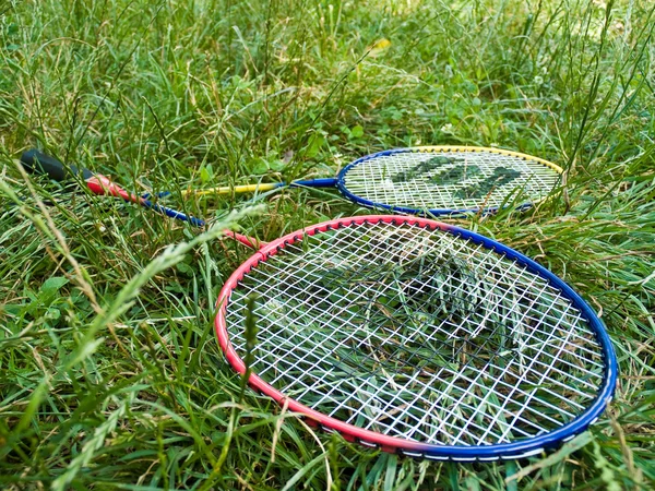 stock image Two badminton rackets in grass