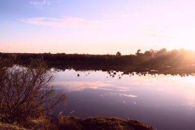 Sunset sky over a lake clipart