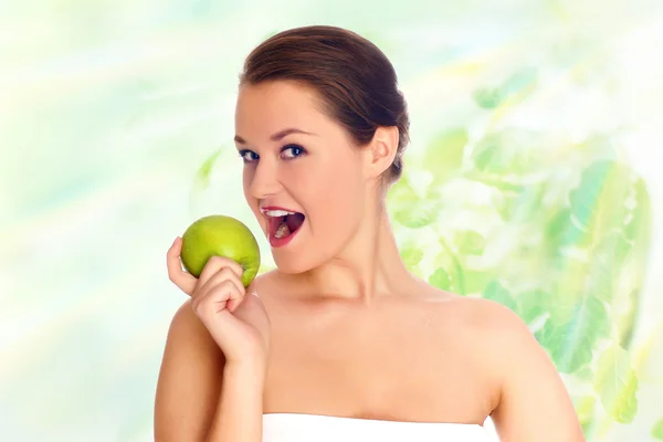 Junge Frau isst Apfel und lächelt — Stockfoto