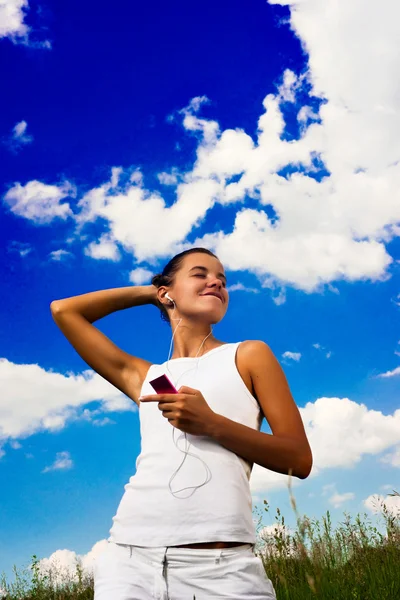 Vacker ung flicka lyssna musik — Stockfoto
