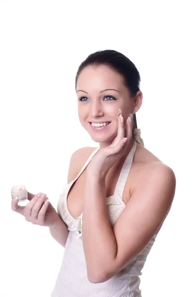 Young woman applying creme on face — Stock Photo, Image