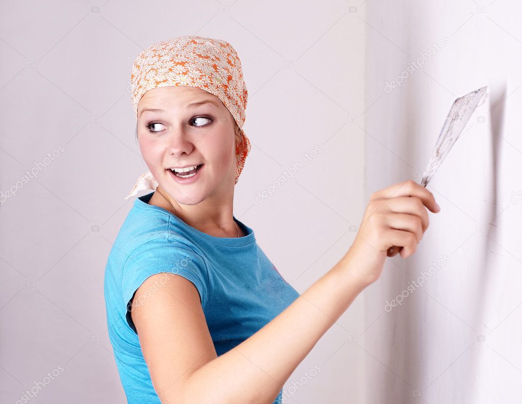 Female make repairs in the apartment