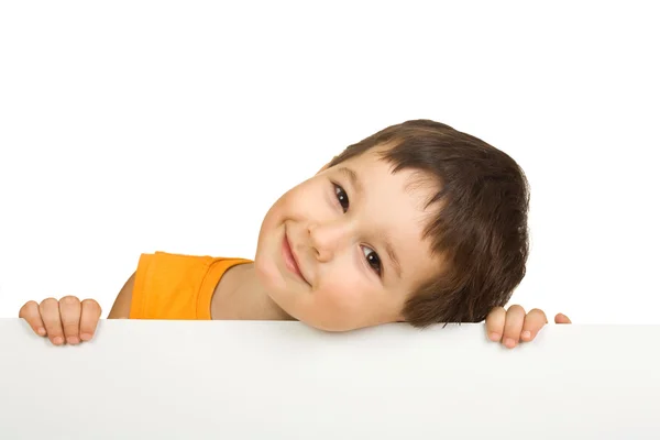 Sorrindo menino segurando um sinal em branco — Fotografia de Stock