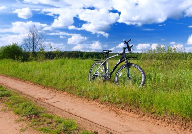 Bicycle in summer rural scene clipart