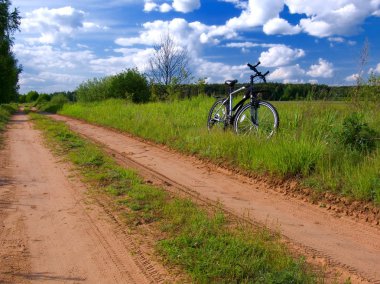 Bicycle in summer rural scene clipart