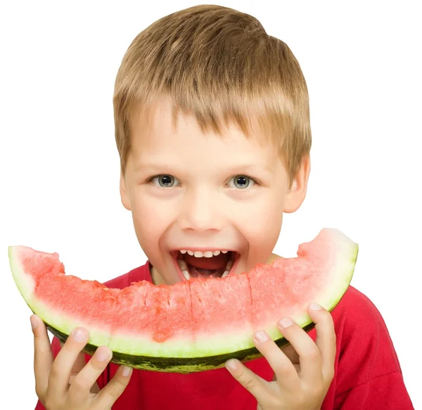 Chlapec jí kus melounu — Stock fotografie