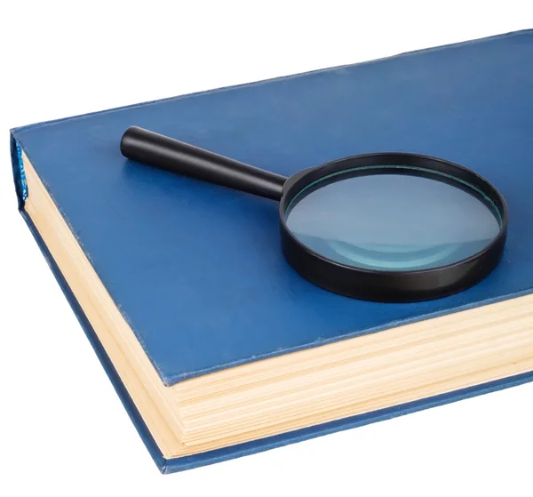 Förstoringsglas på en blå bok — Stockfoto