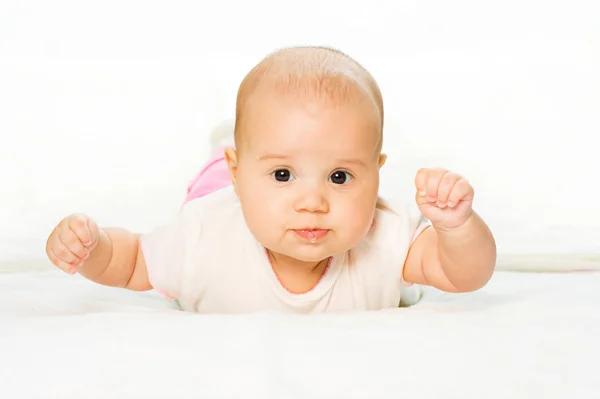 Playing baby is on abdomen and white ba — Stock Photo, Image