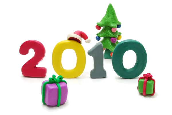 Text 2010, vánoční stromek a dárky — Stock fotografie