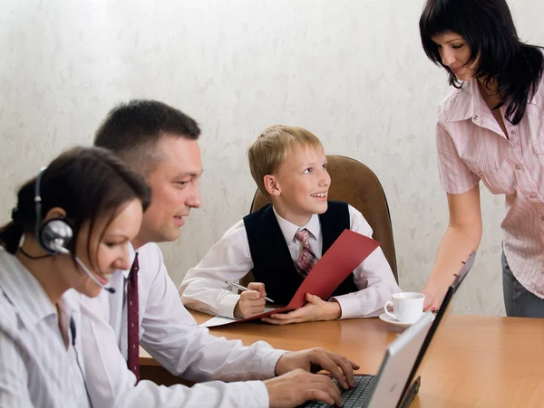 Young boy as a boss in the office with e — Stock Photo, Image