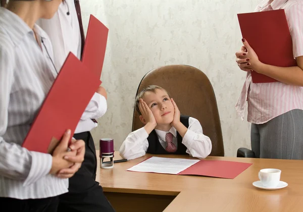 A boy of five at the office desk as a bo — Stock Photo, Image