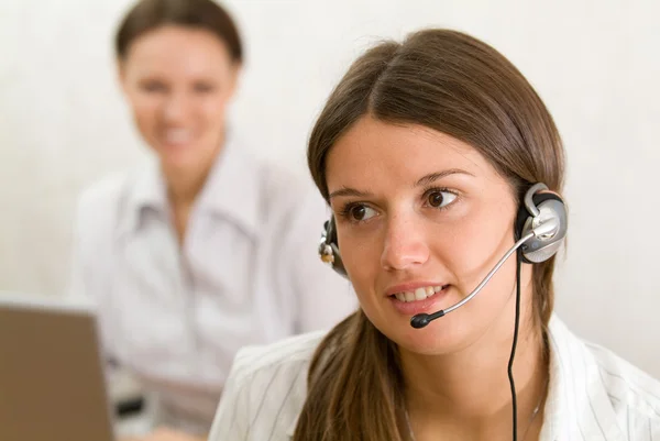 Young girl with headset in the office — Stock Photo, Image