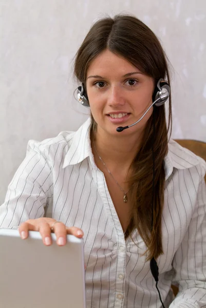 Smart busineswoman with a headset and la — Stock Photo, Image