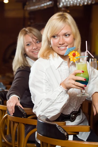 Two blonds at a bar counter with a cockt — Stock Photo, Image