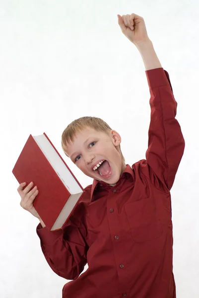 Niño con camisa roja salta de un libro — Foto de Stock