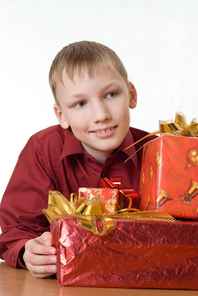 stock image Happy boy in a red shirt with gifts